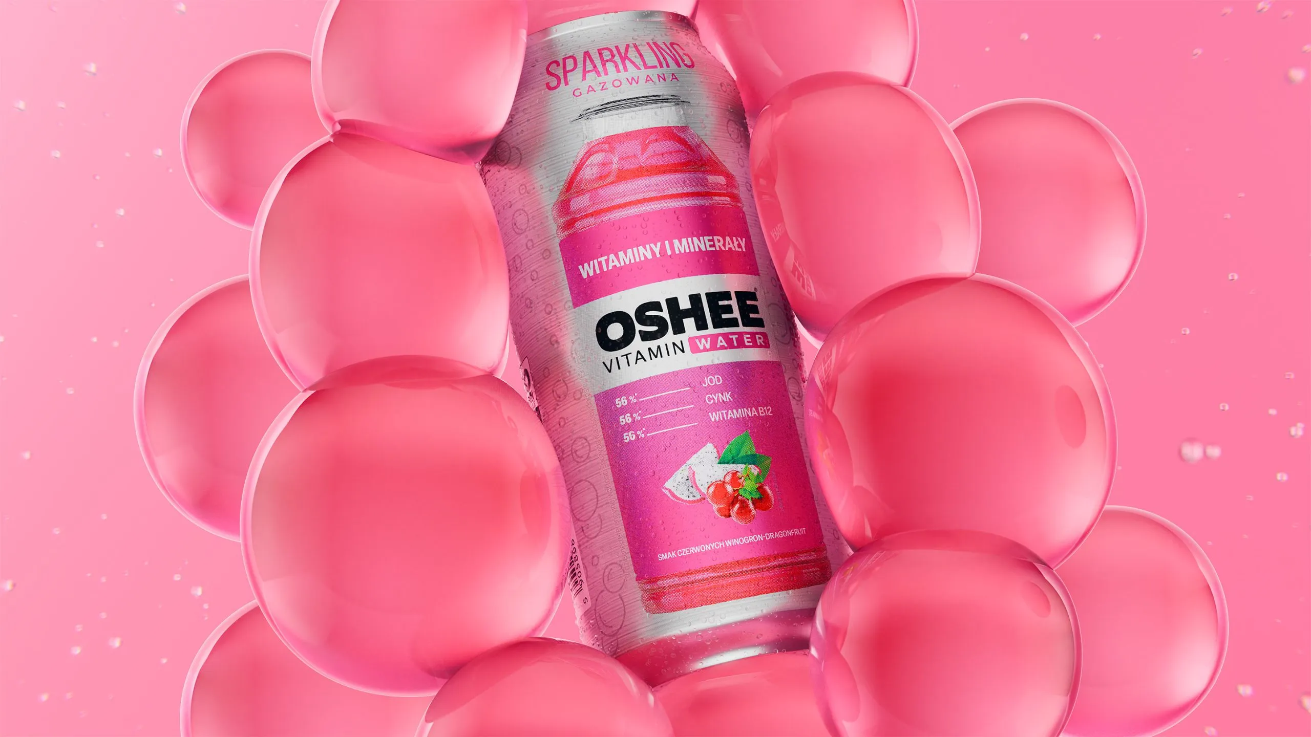 OSHEE Sparkling Vitamin Water bottle, red grape and dragon fruit flavour, framed by a ring of oversized glossy pink bubbles on a pink background, 3D CGI product render